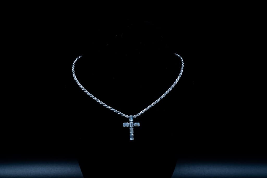 Diamond baguette cross pendant on a rope chain