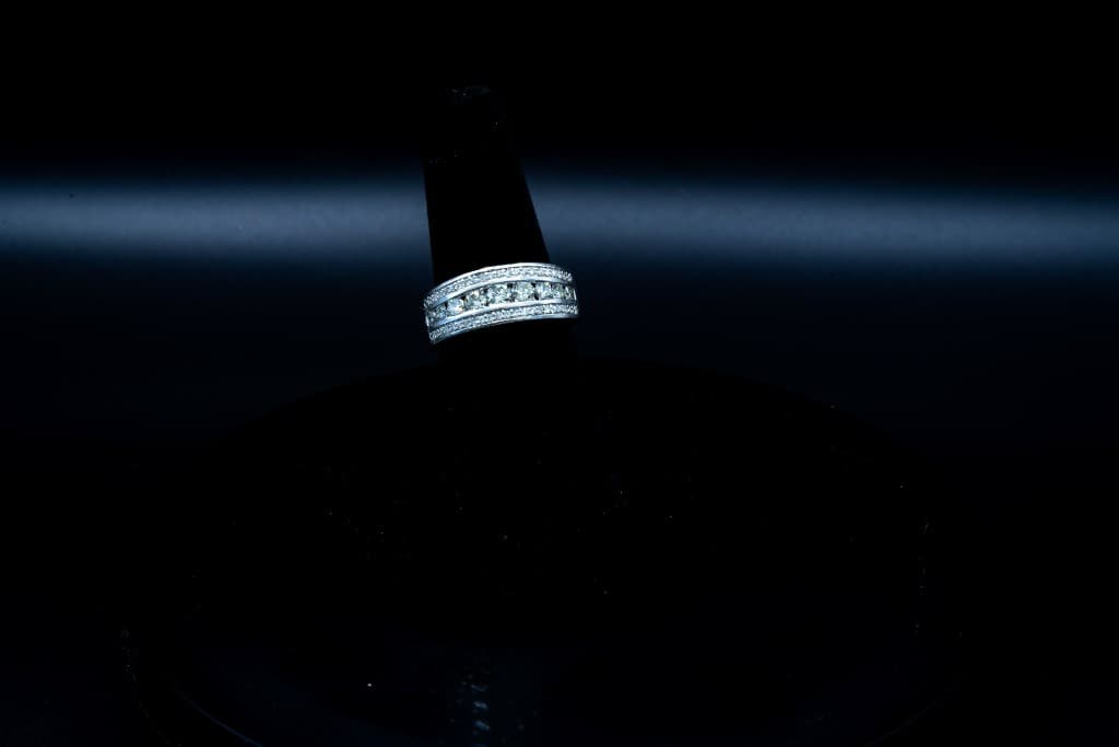 Diamond channel-set band ring on a display stand